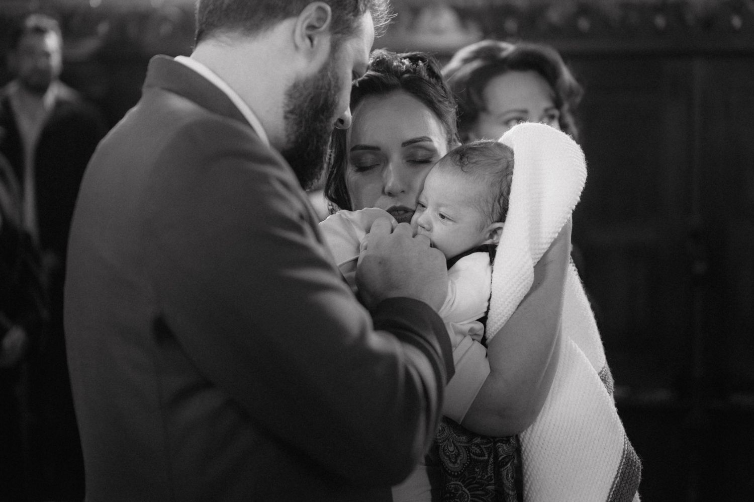 Black and white photo of an intimate moment during a religious ceremony.