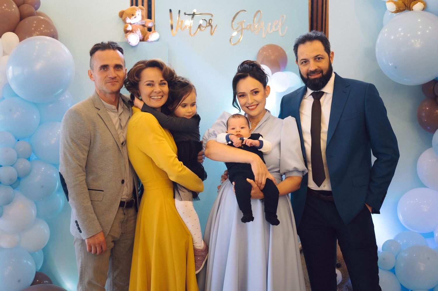 A celebration gathering with blue balloons and elegant attire at a festive party event.