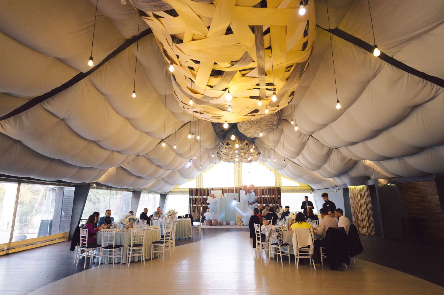 Elegant reception hall with dramatic yellow and white ceiling treatments.