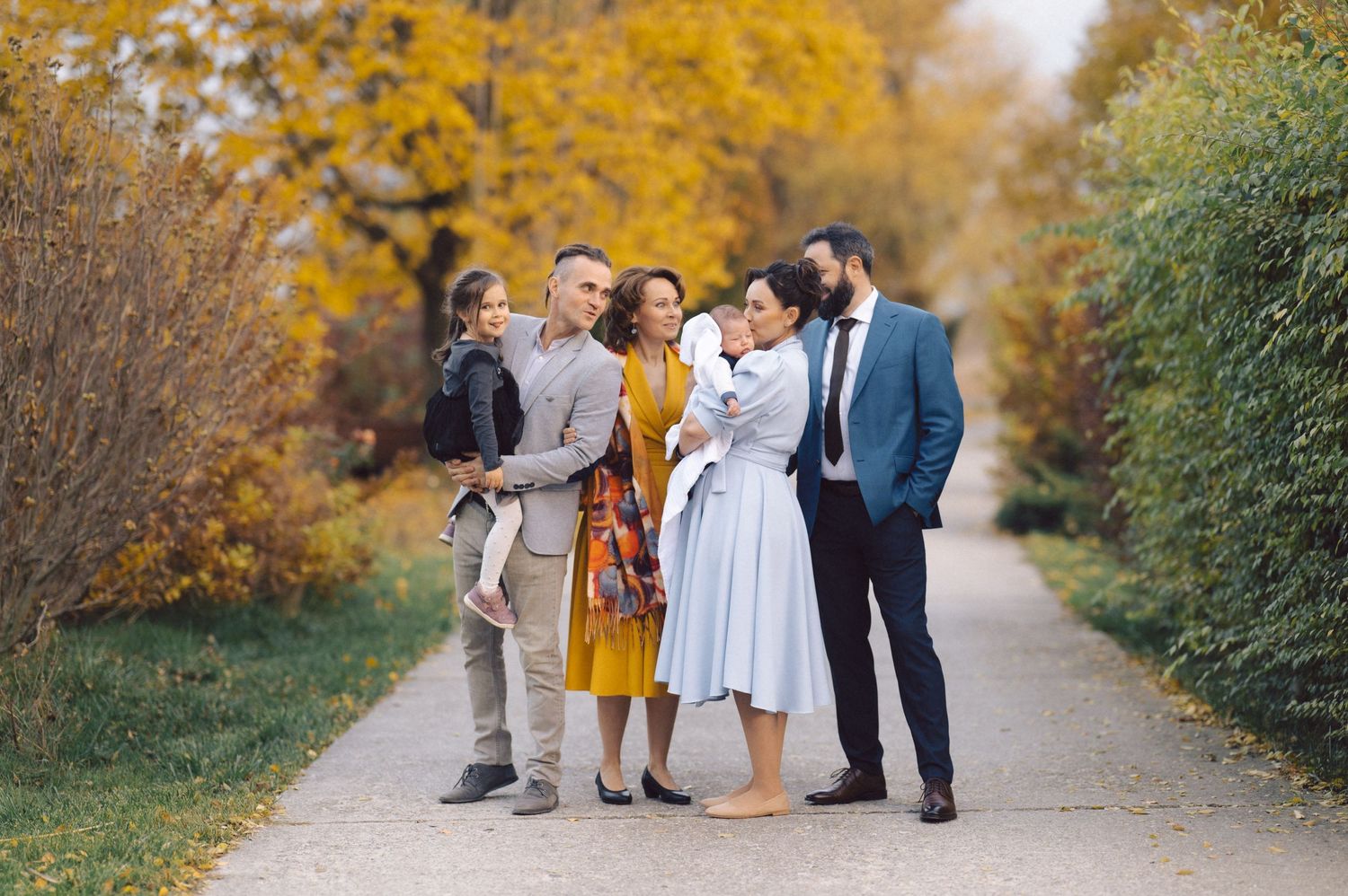 Small gathering of friends on walkway surrounded by fall colors.
