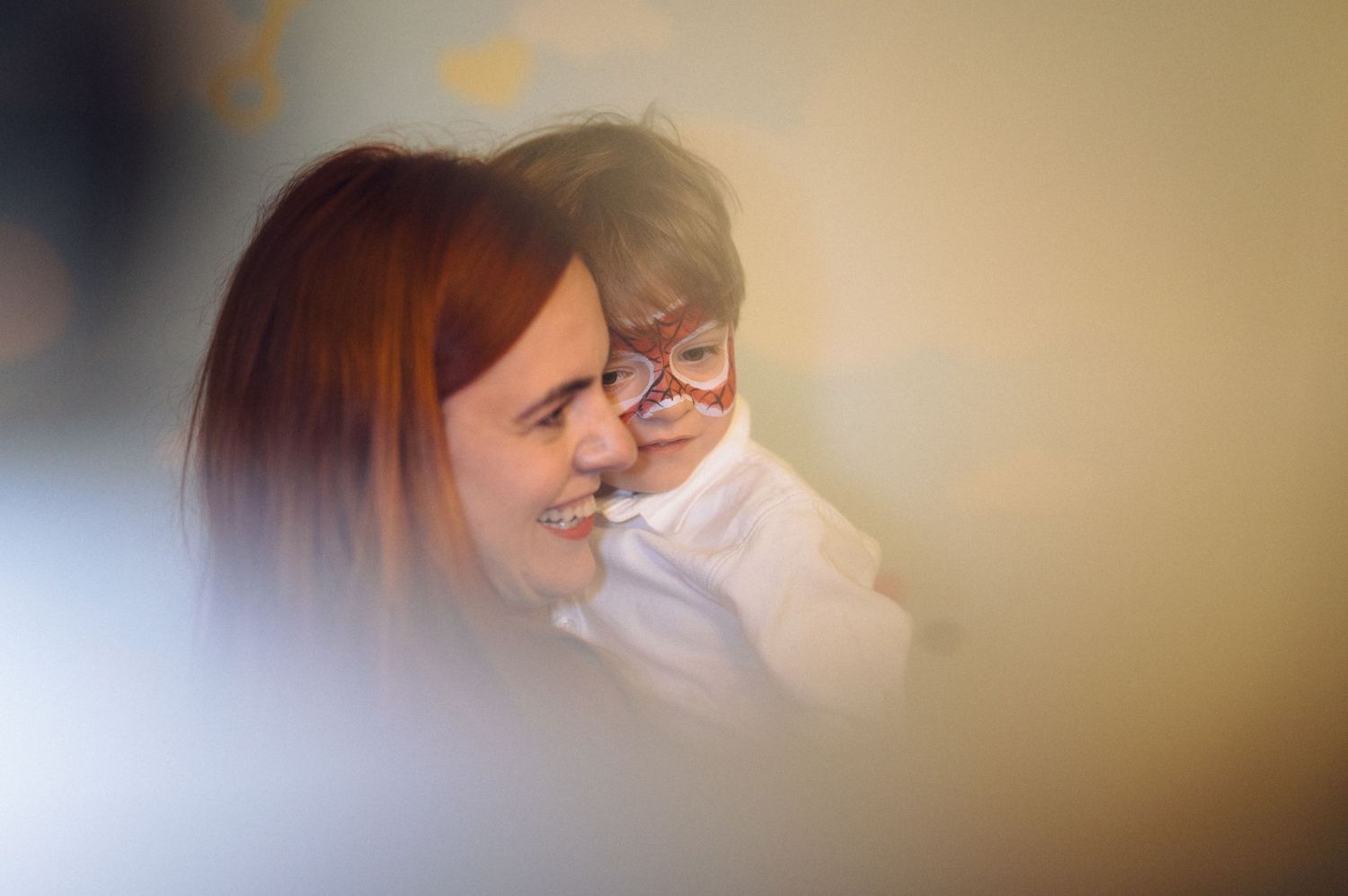 Two people share a joyful moment together in a soft-focus candid shot.