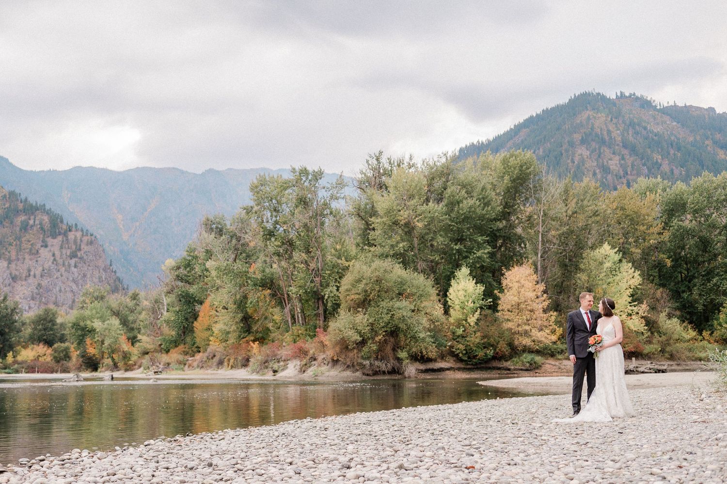 wedding couple along riverbank in Leavenworth Waterfront Park