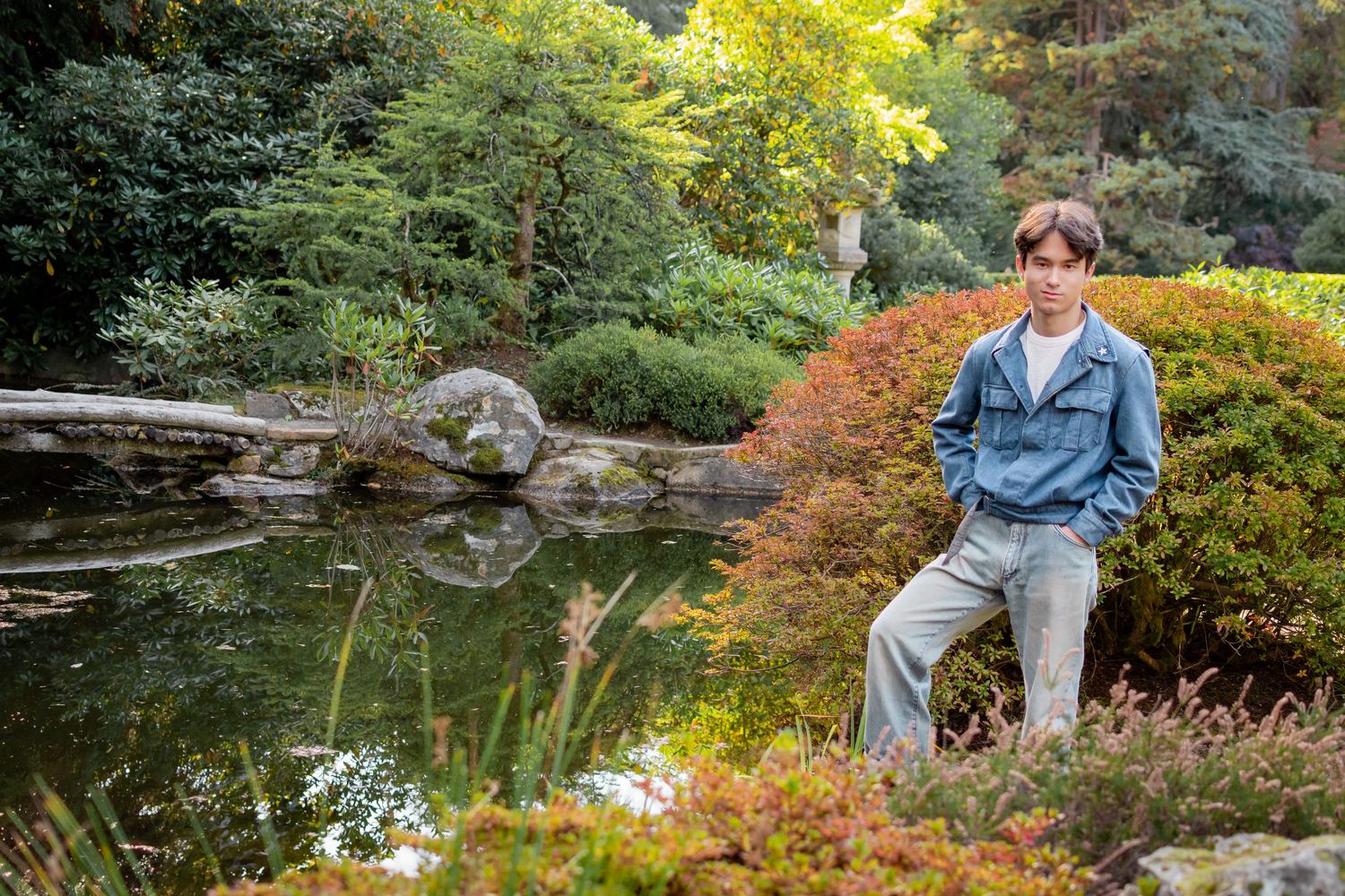 Senior standing near reflective pond at Kubota Garden, Seattle senior photography