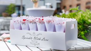 Wedding invitations and place cards displayed with elegant floral decorations and calligraphy on white paper.