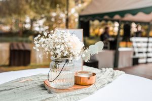 Elegant wedding rings displayed with delicate baby's breath flowers and rustic details in natural lighting.