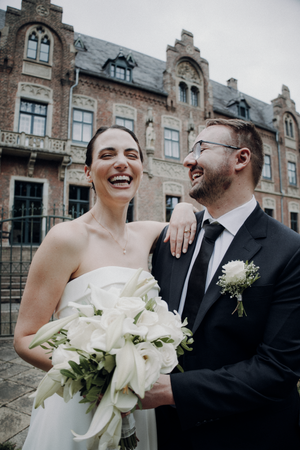 A sequence of candid wedding moments captured against a historic brick building backdrop with white floral bouquet.