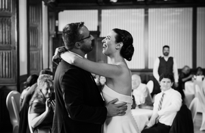 Black and white photo of couples dancing together at an elegant wedding reception.