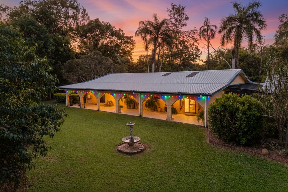 Scenic sunset views over a tropical property with palm trees and lush landscaping at dusk.