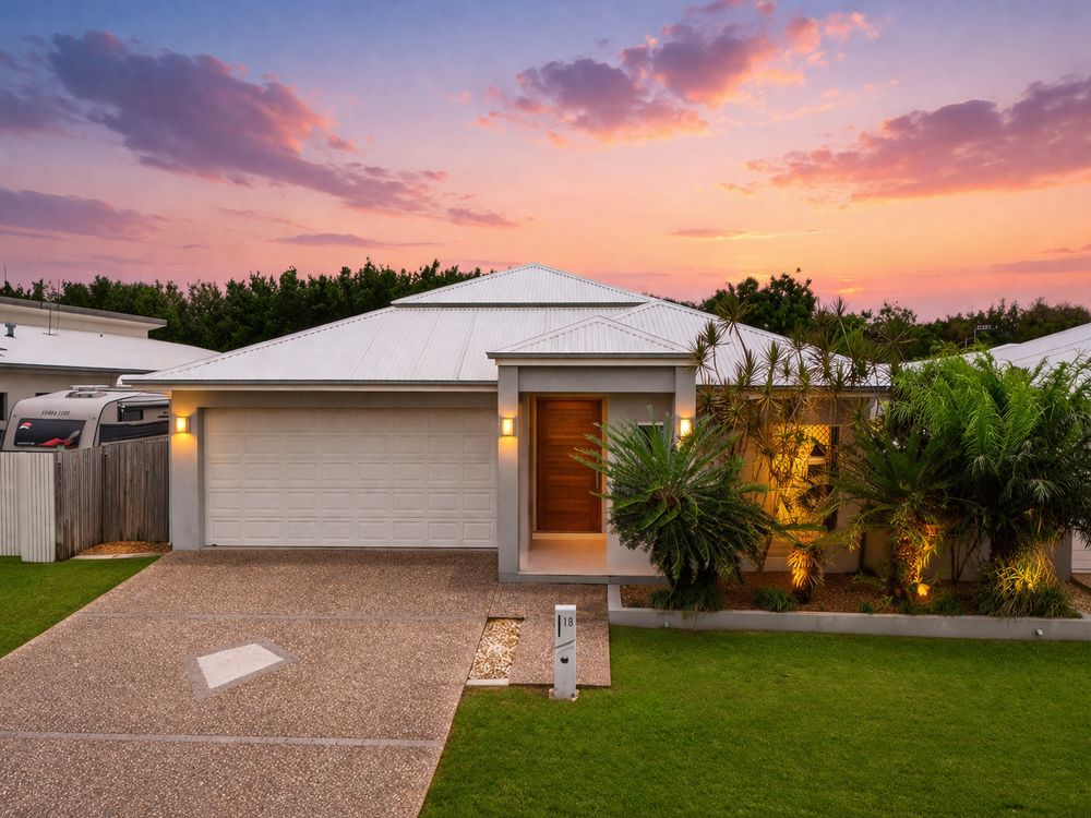 Panoramic exterior view of a modern single-story home at sunset with a paved driveway and manicured landscaping.
