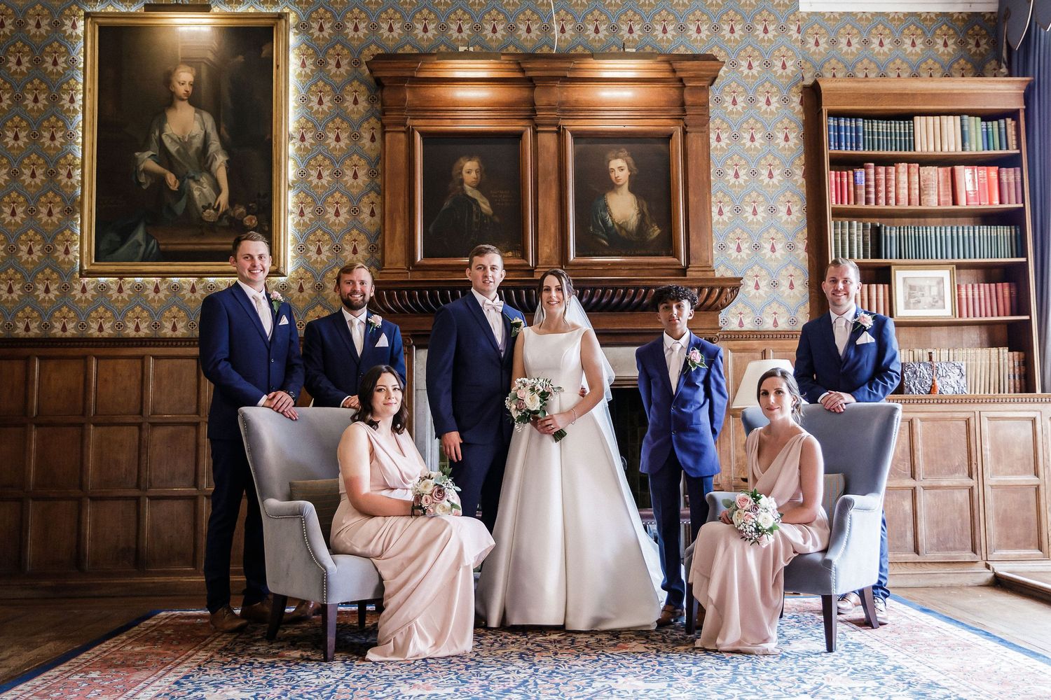 Wedding group photograph in the Hodsock Priory Panelled Hall taken during wet weather