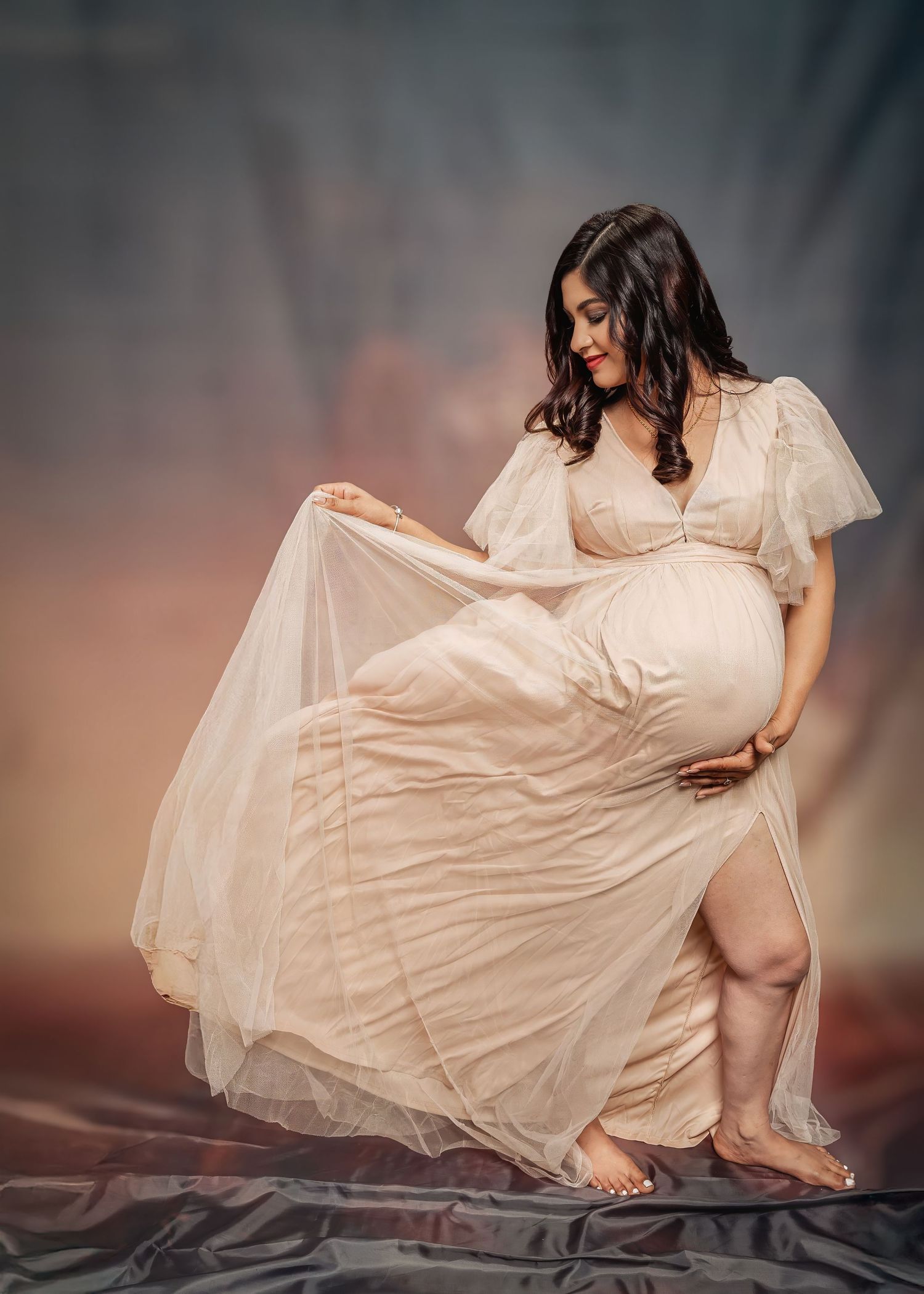 A flowing white dress billows gracefully in a series of artistic dance-like movements against a moody dark background.