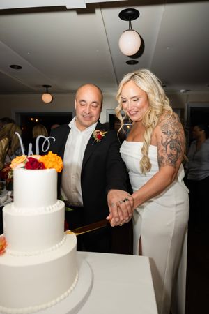 A sequence of wedding photos showing a couple cutting and sharing their elegant white wedding cake with pearl details.