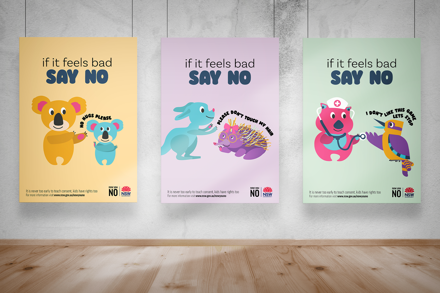 Three colorful anti-bullying posters featuring cartoon animals with the message 'If it feels bad SAY NO' displayed on a wall.