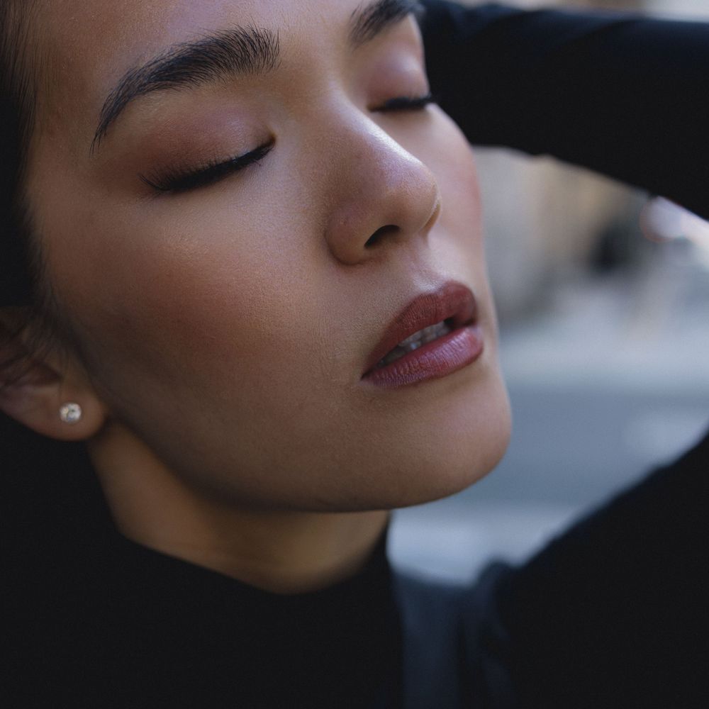 Close-up portrait series showing dramatic shadows and makeup details in artistic beauty photography.