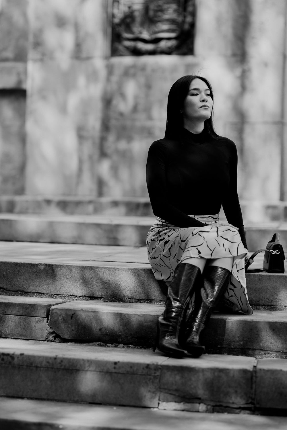 Black and white artistic portrait series showing a person reclining on stone steps in different contemplative poses.
