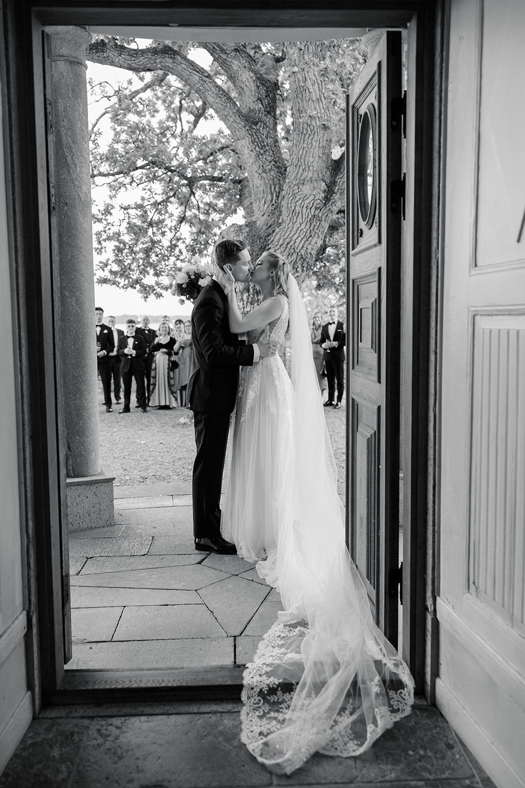 Black and white photo sequence showing a bride in a flowing white wedding dress walking through church doorways.