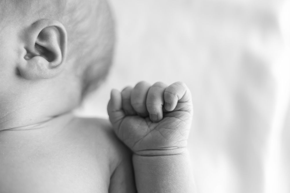 Close-up detail photography of newborn girl during a hospital newborn session in Sydney. documentary style black and white.