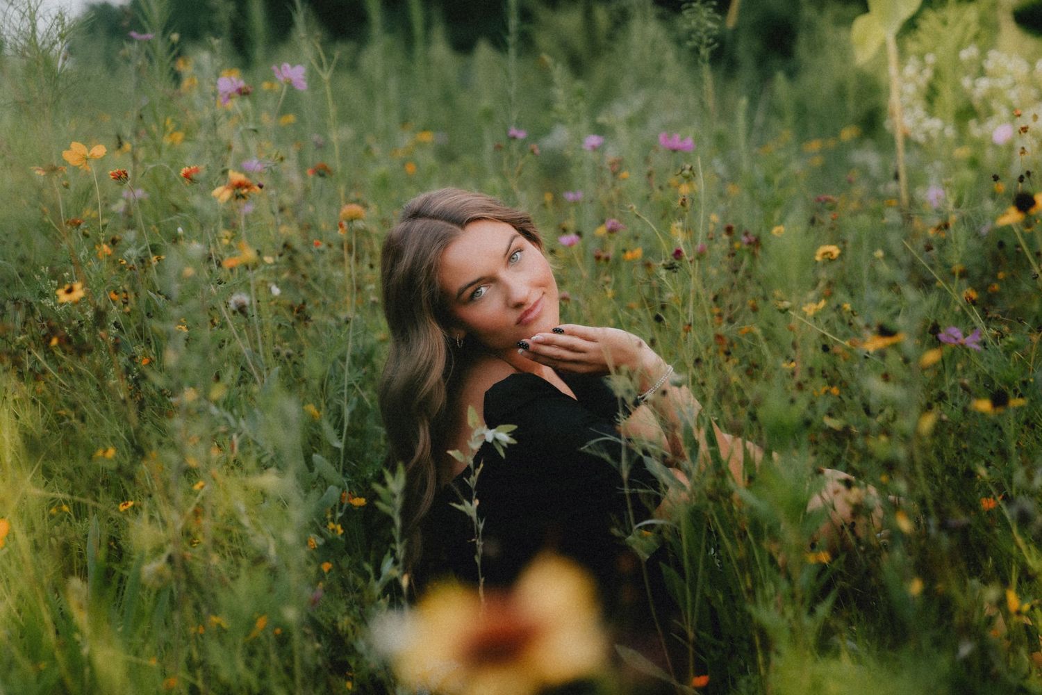 Ethereal summer photography in a meadow filled with yellow flowers and natural greenery.