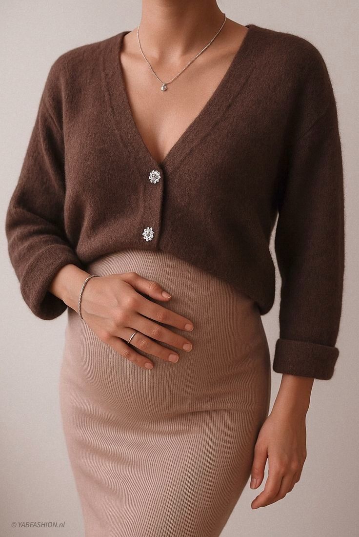 Close-up view of a brown knit sweater paired with a beige fitted dress showing texture and layering details.
