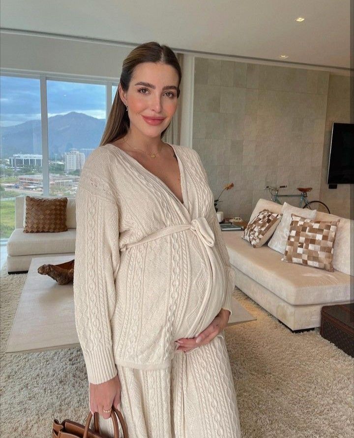 Series of photos showing a cream cable knit maternity dress in a modern, bright interior setting.