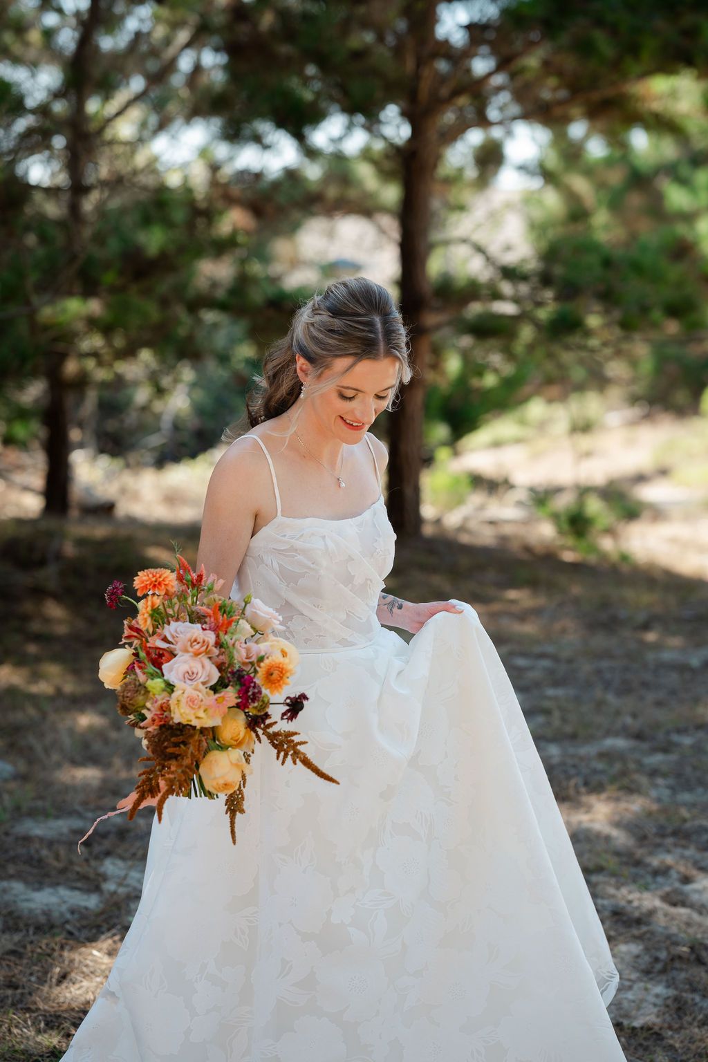 The composition features a bride in a white dress holding an autumn floral bouquet against an outdoor backdrop.