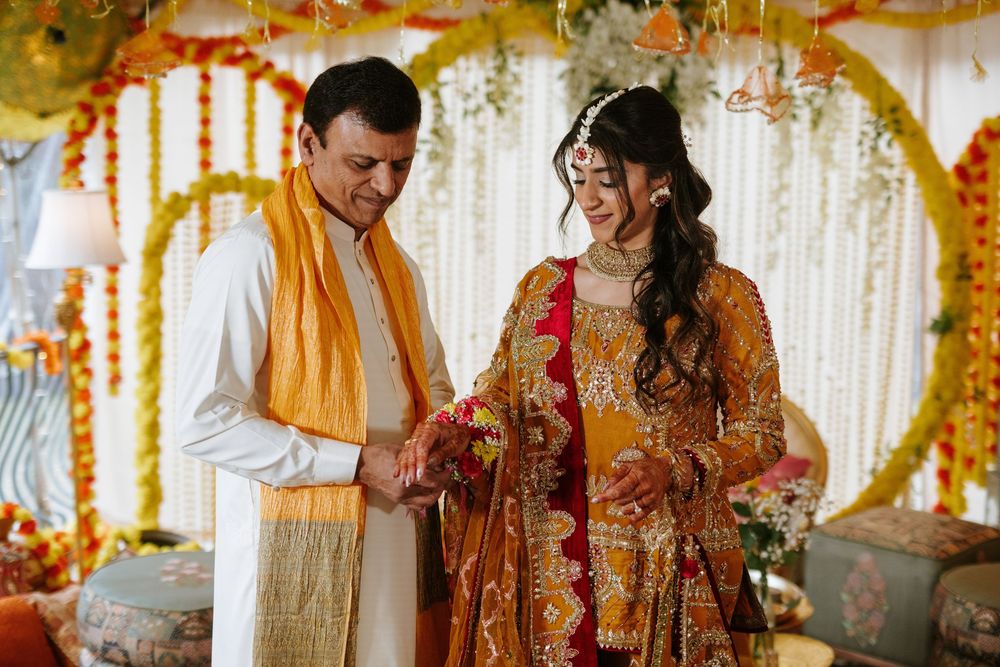 A traditional Indian wedding ceremony with couple in red and gold attire surrounded by floral decorations.