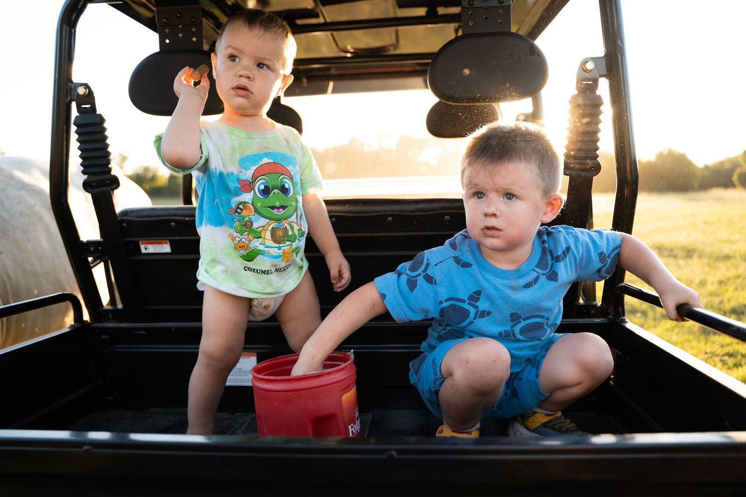 Tulsa photographer captures kids helping feed cows during Family documentary photography session in Oklahoma