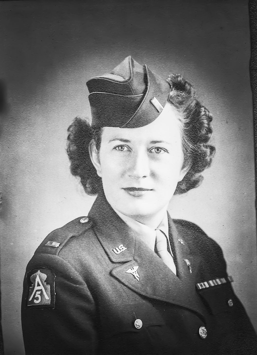 Historical black and white portraits of women in military uniforms.