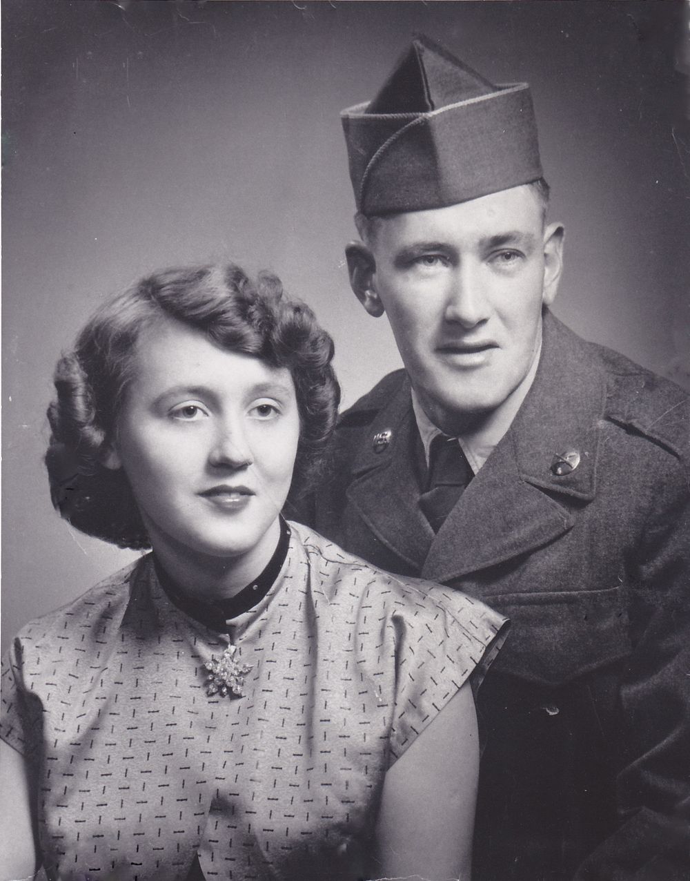 Vintage black and white photos showing military couples in formal attire.