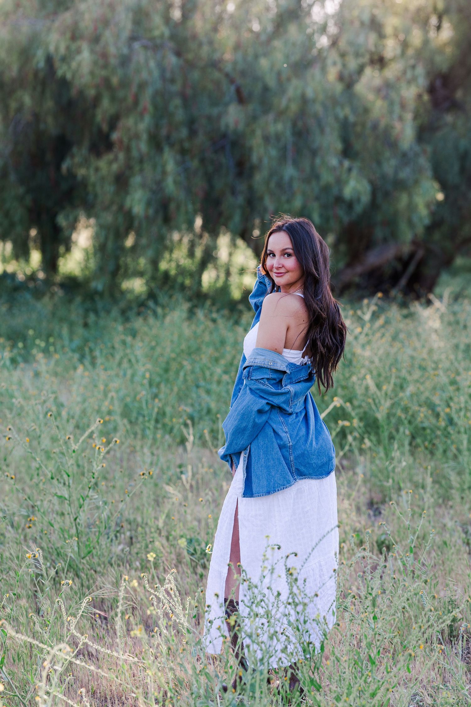 A high school senior enjoying a professional outdoor photoshoot in Simi Valley, CA, captured in soft natural light with a light and airy pho