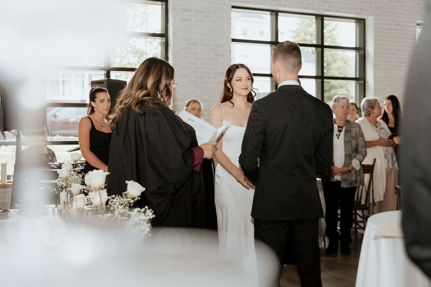 Bride and groom holding hands during intimate Tire Shack Brewery wedding photographer Moncton photography timeless luxury photography