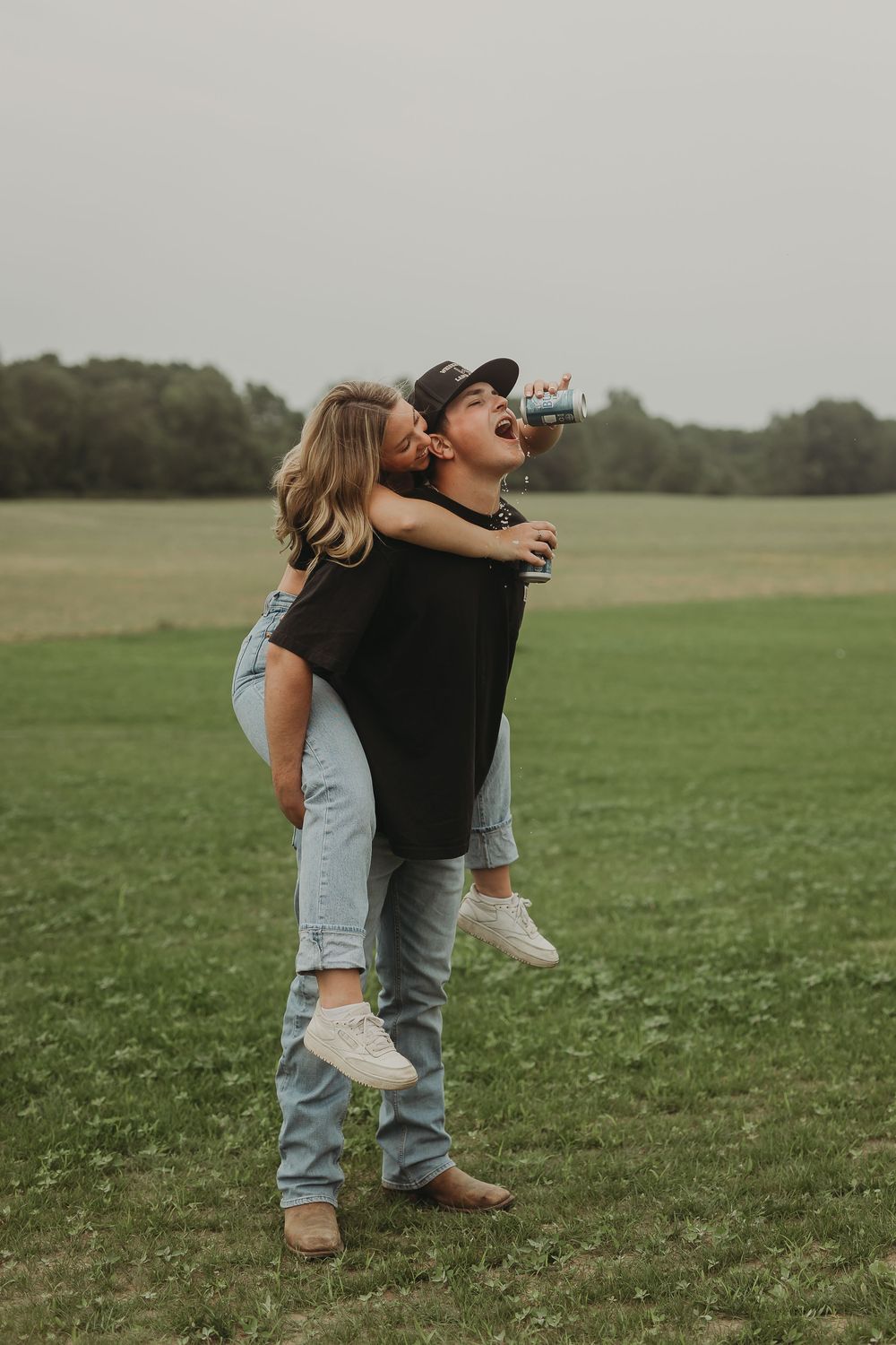 A joyful piggyback moment captured in a grassy field on an overcast day.