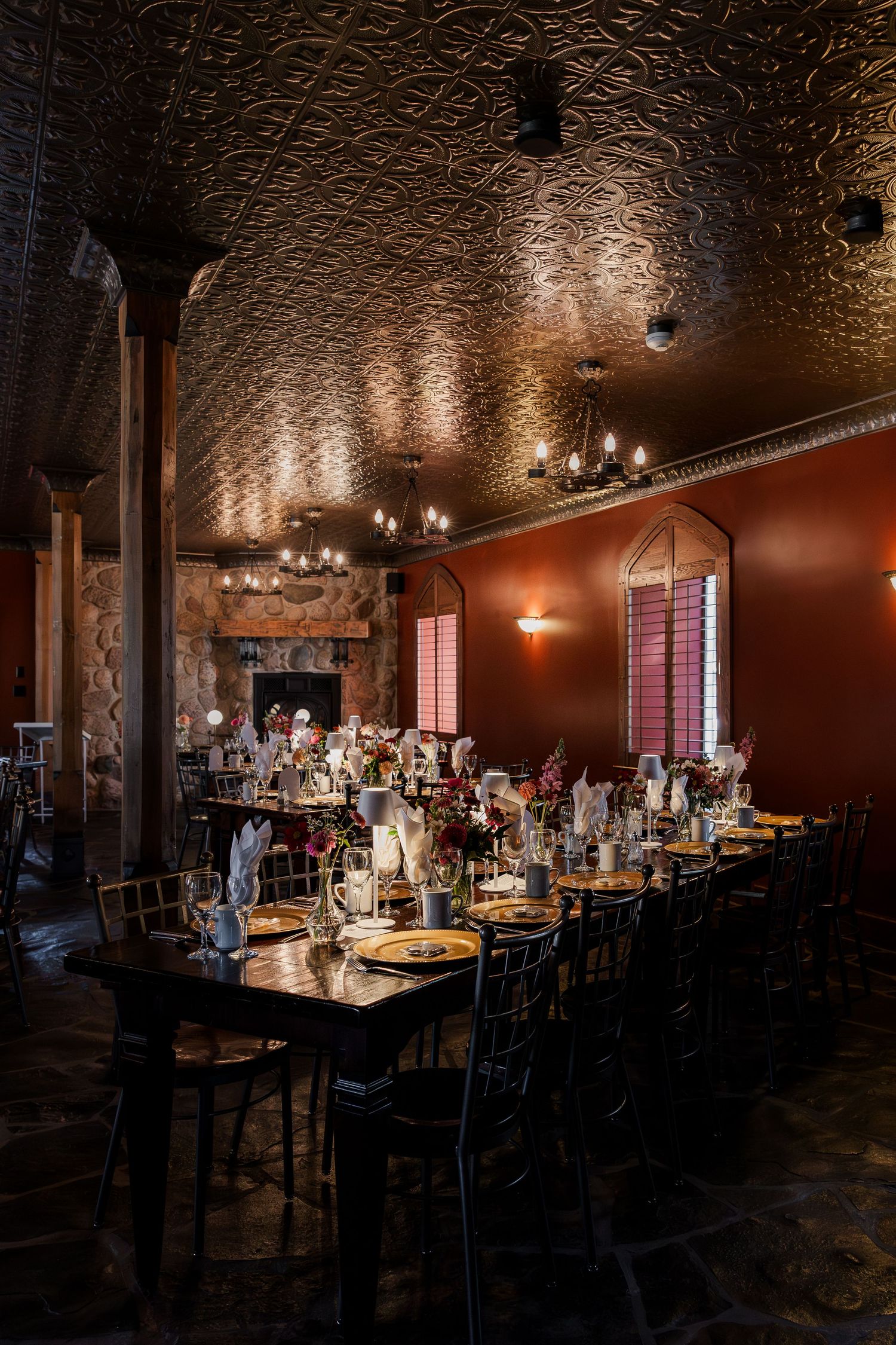 Elegant reception venue with ornate ceiling details and romantic mood lighting at at Hauser Hall in Kitchener, Ontario.