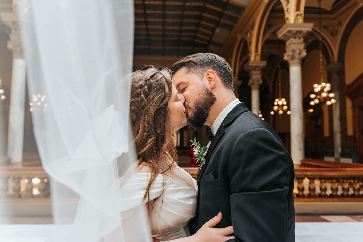 A romantic wedding kiss sequence captured in a beautiful church setting with gothic architecture and warm lighting.