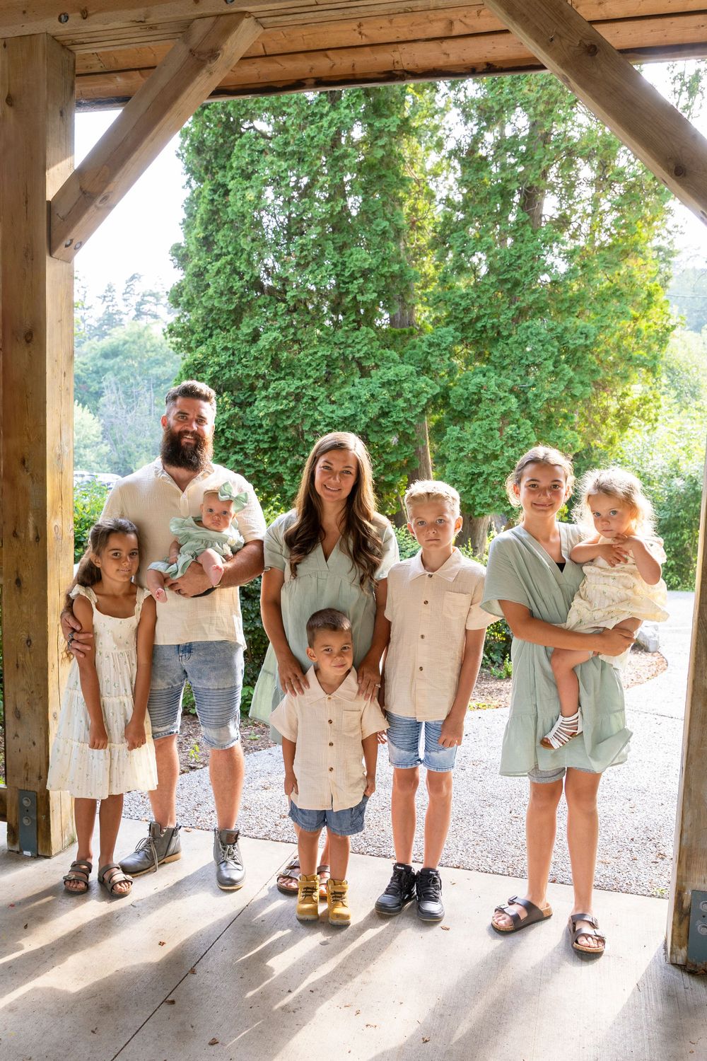 Family of 8 at Orono park under a gazebo looking at the camera