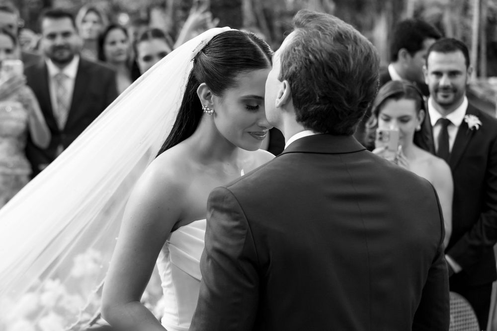 A black and white montage of wedding photos showing various romantic moments between a couple.