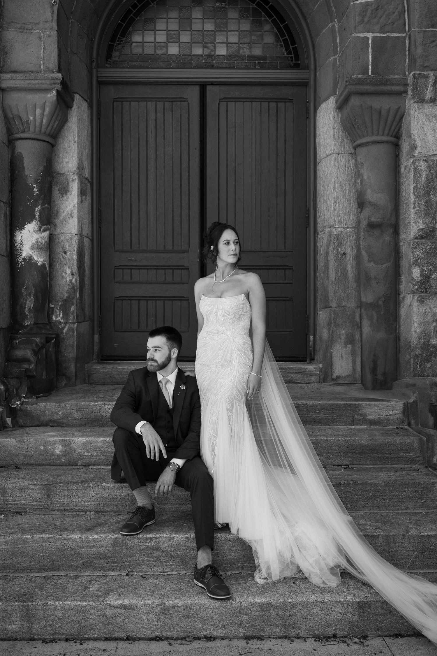 A black and white artistic sequence of wedding photos showing a bride and groom sitting on stone steps in a vintage setting.