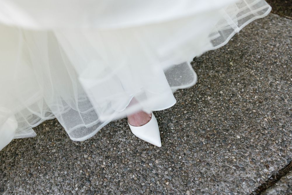 White plastic bags containing groceries sit on a textured gray surface.