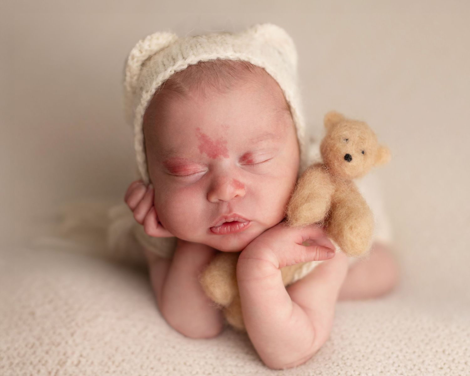 A series of newborn baby portraits showing peaceful sleeping poses with a small teddy bear companion.