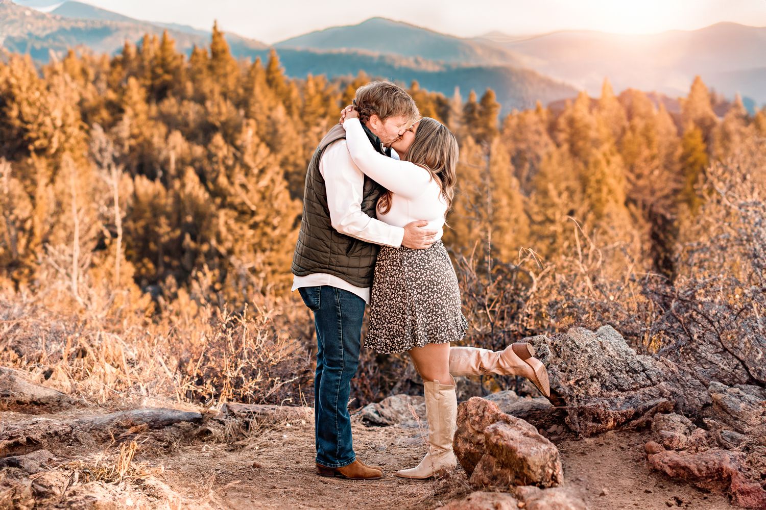 a couple embracing on a Colorado mountaintop