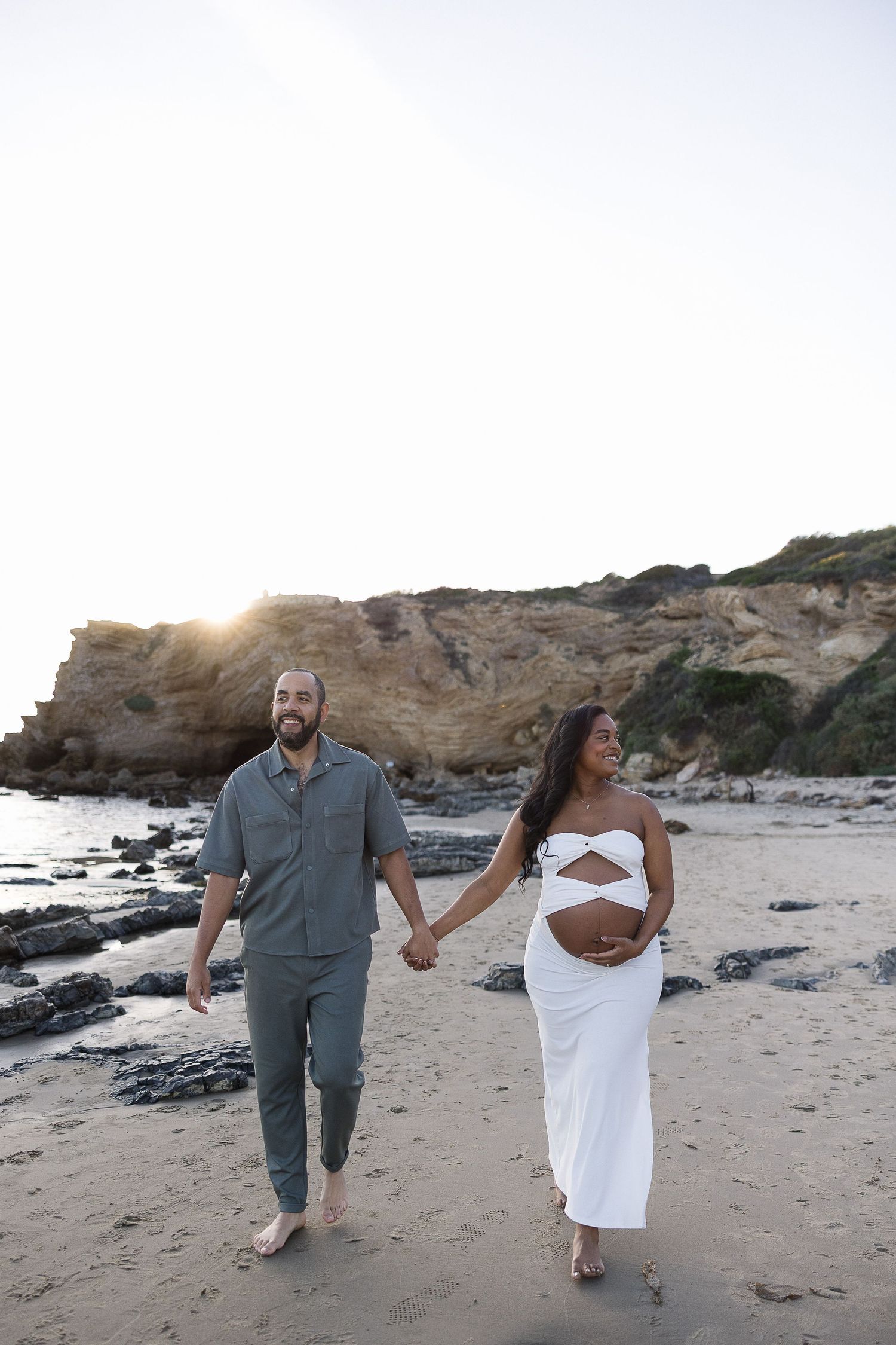 Beach maternity photoshoot with husband in Huntington Beach during sunset