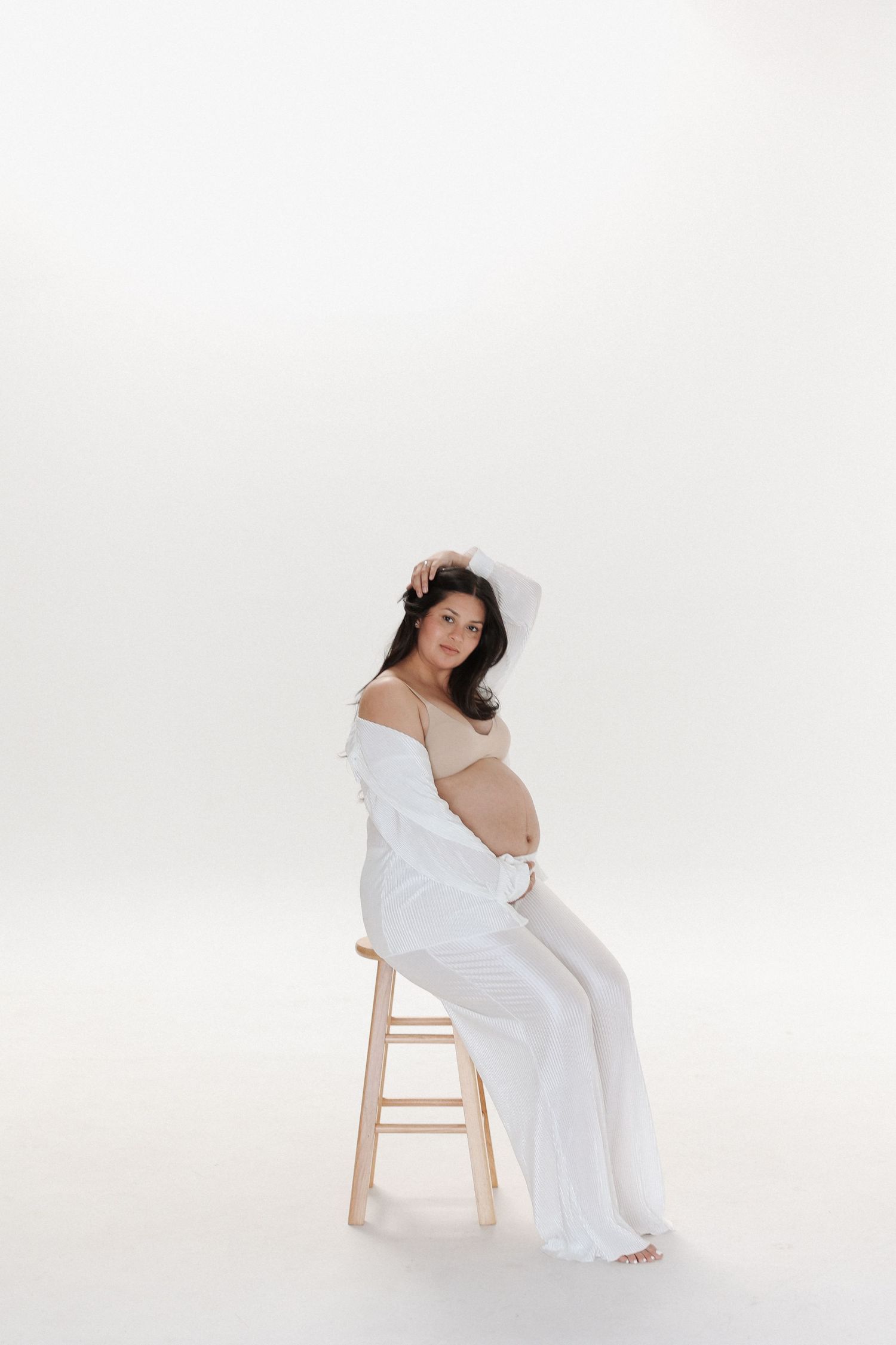 Maternity photography in studio LA with soft lighting and simple backdrop