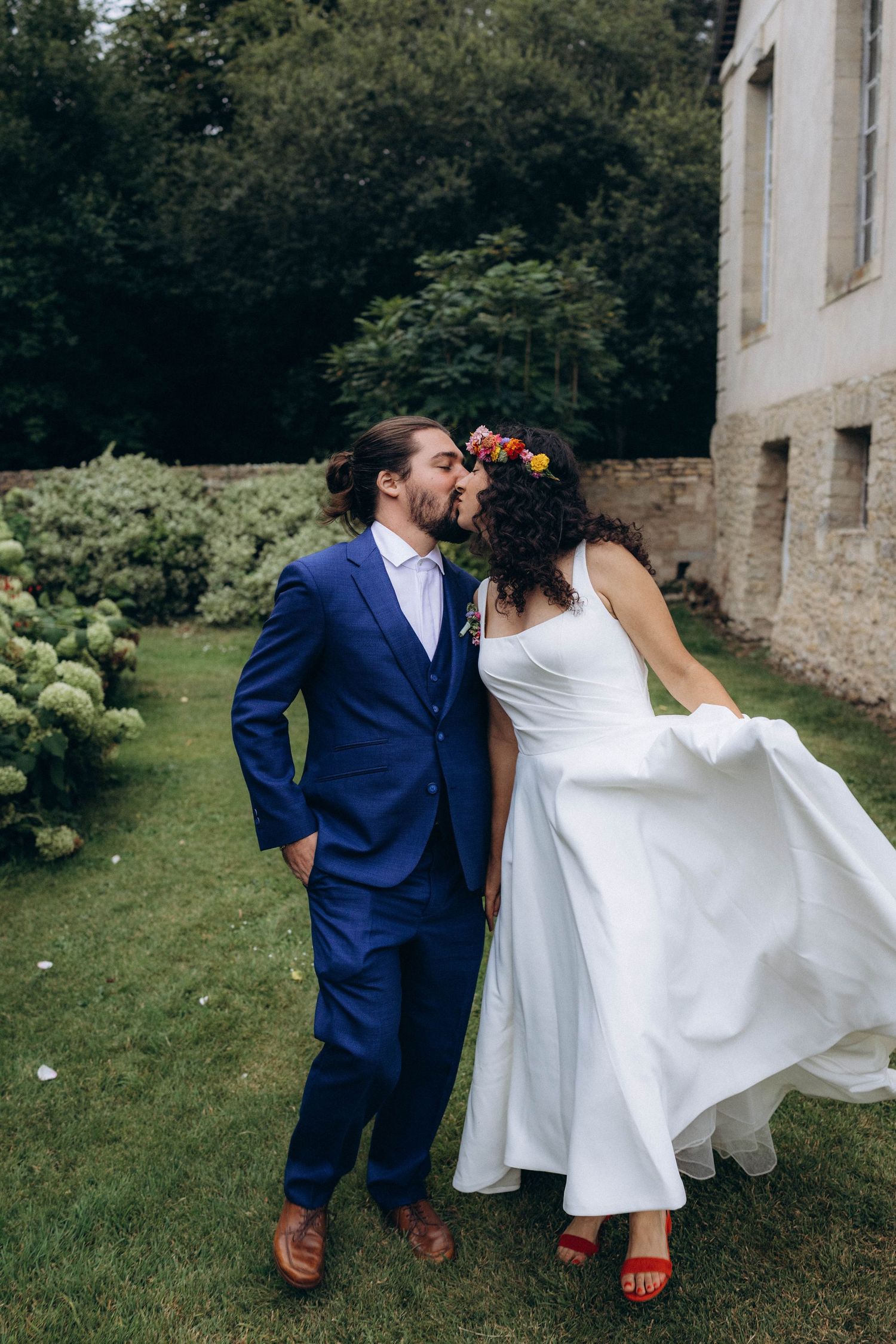 A tender autumn embrace captured during a wedding photoshoot with fall foliage.