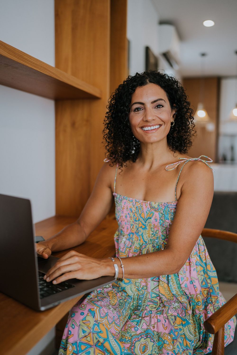 A series of casual work-from-home photos showing someone using a laptop at a wooden desk.