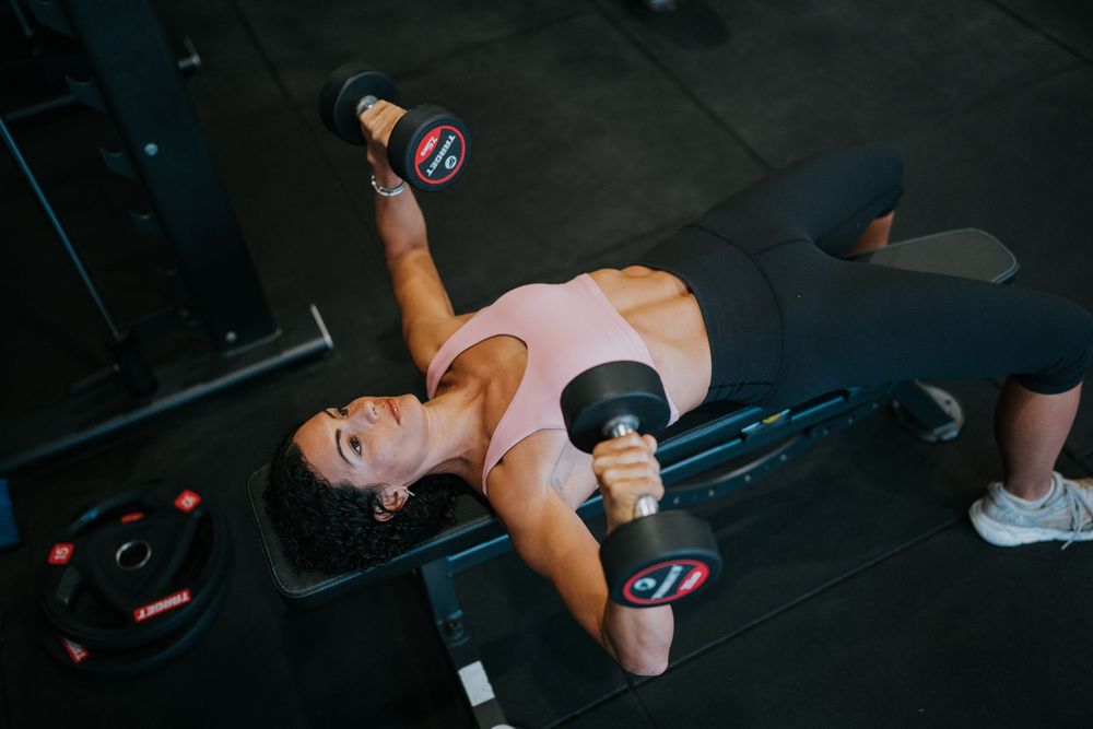 Fitness training sequence demonstrating proper form on cable machine at gym.