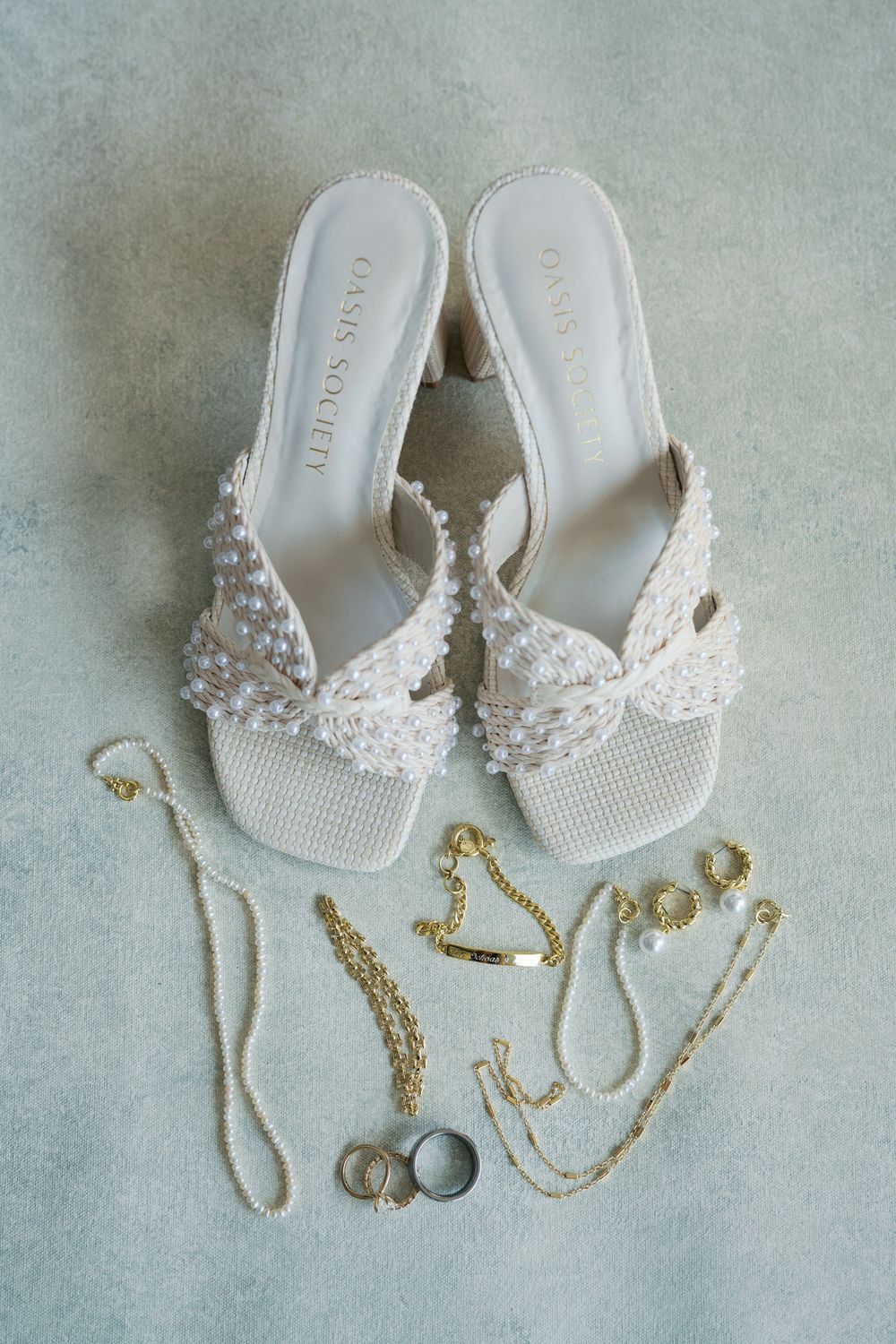 Elegant white beaded bridal flip flops with gold jewelry displayed on a light blue background in three similar shots.