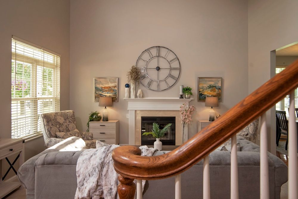 A modern farmhouse-style room with natural light, wall clock, and warm wooden accents.