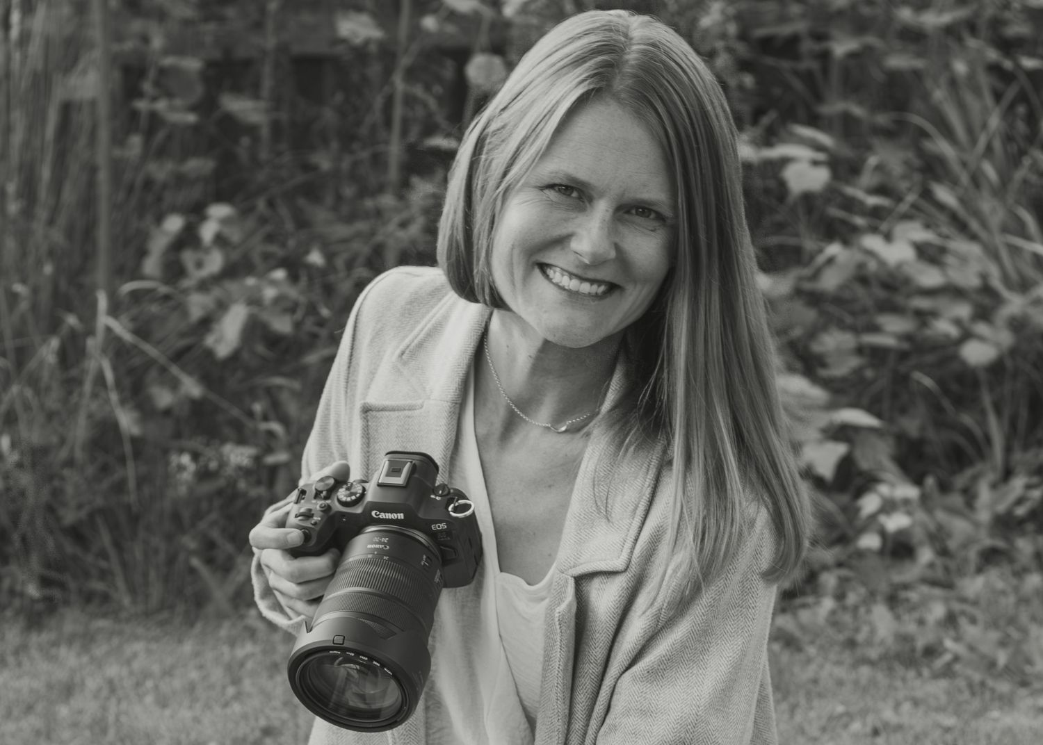 Black and white portrait series showing someone holding a camera outdoors.