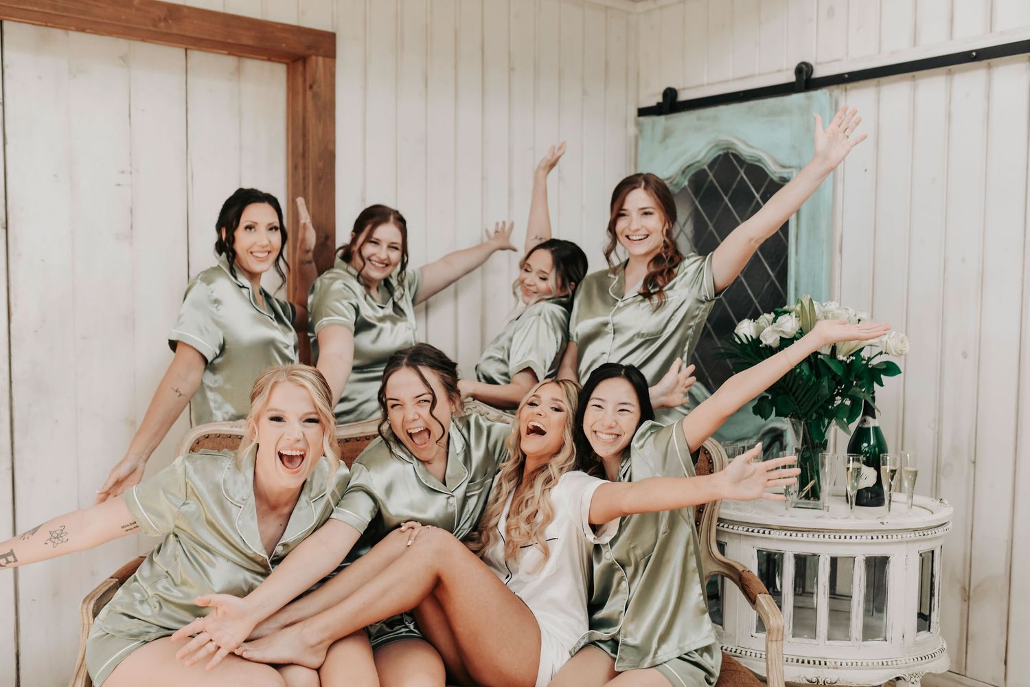 Bride laughing as bridesmaids cheer during first look