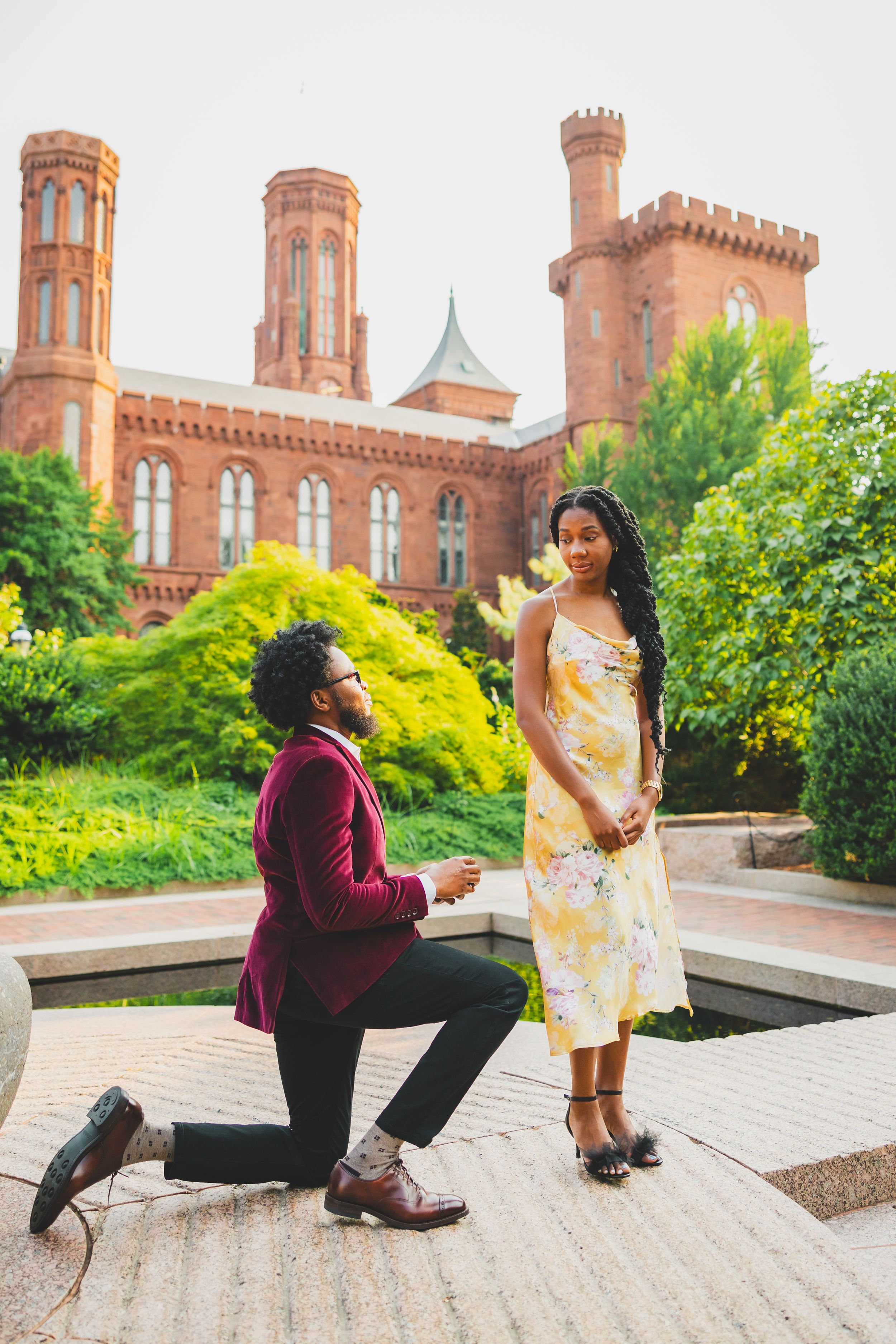 A romantic Enid A. Haupt proposal moment unfolds on the steps of a grand castle-like building